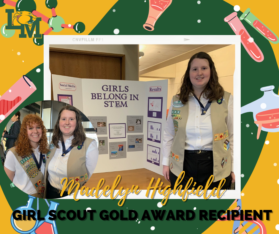 girl scout student smiles while standing in front of poster board